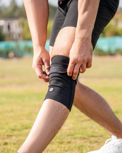 Runner tying a shoe while wearing TheraCopper copper knee sleeves