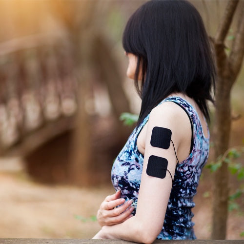 Two electrode pads on the back of an upper arm