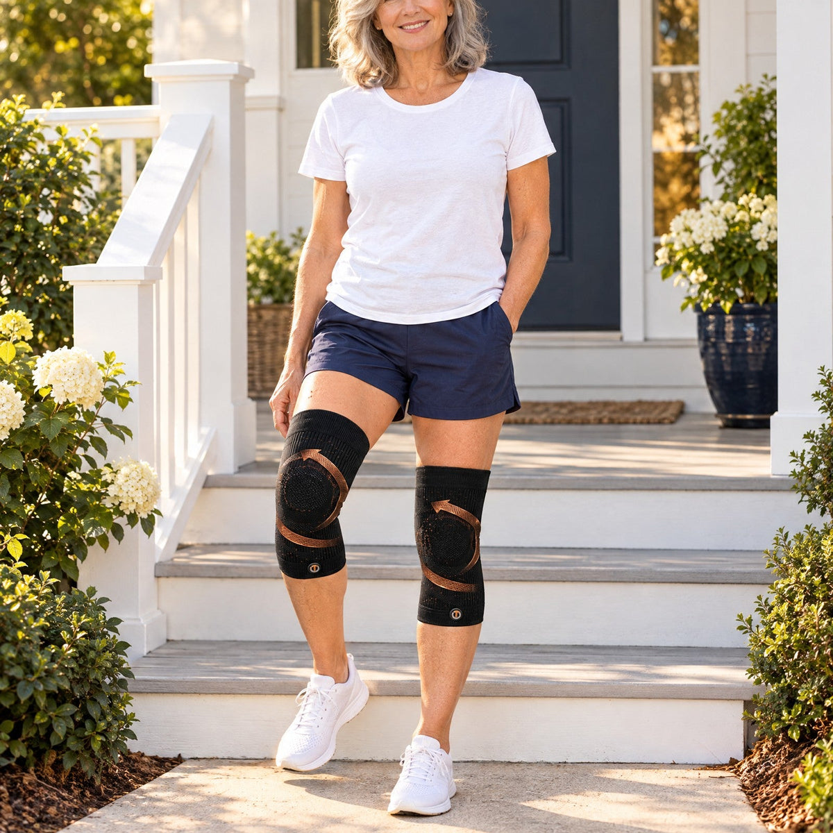 Woman at her porch steps wearing copper compression knee sleeves on both knees