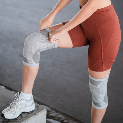 Woman pulling on a MagnetRX magnetic knee sleeve